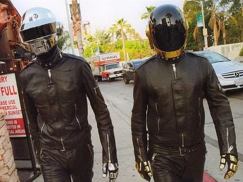 Daft Punk wearing their iconic robot helmets on stage