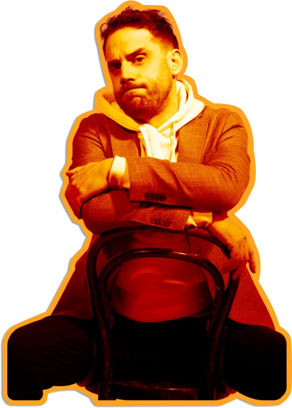 Louis Grenier sitting on a chair with arms folded, ready to talk positioning